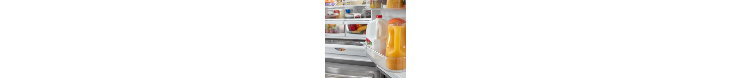 Milk and orange juice containers in a refrigerator door