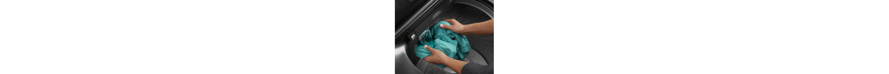 Person placing a blouse inside a top load washer