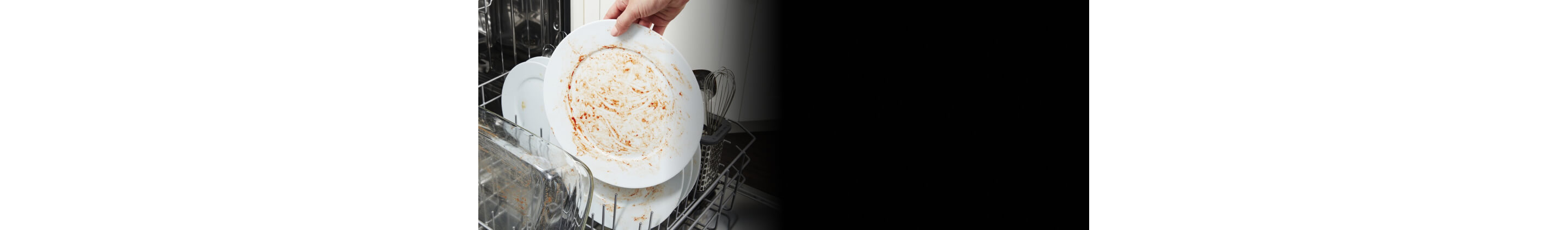 Person loading dirty dishes inside a dishwasher