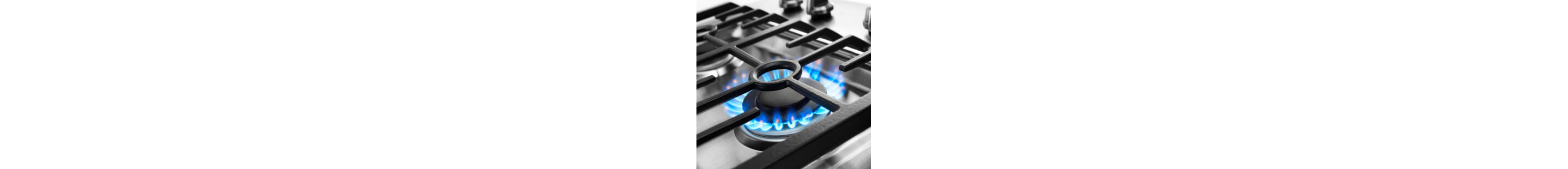 Blue flame simmering under cooktop grates