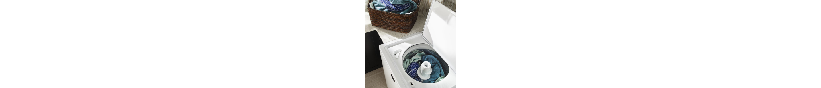 Open top load washing machine filled with laundry