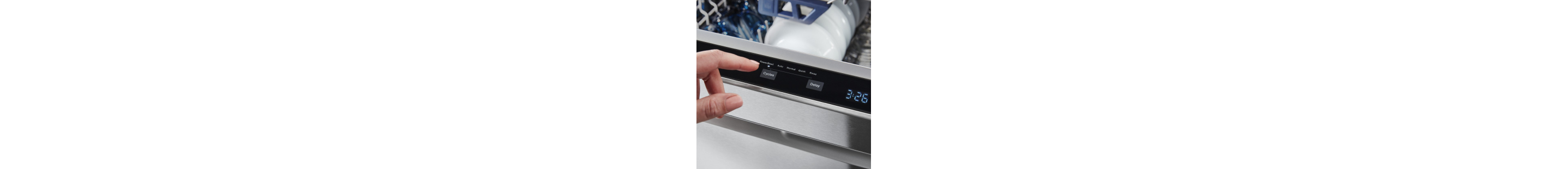 Person selecting a setting on a top control dishwasher control panel