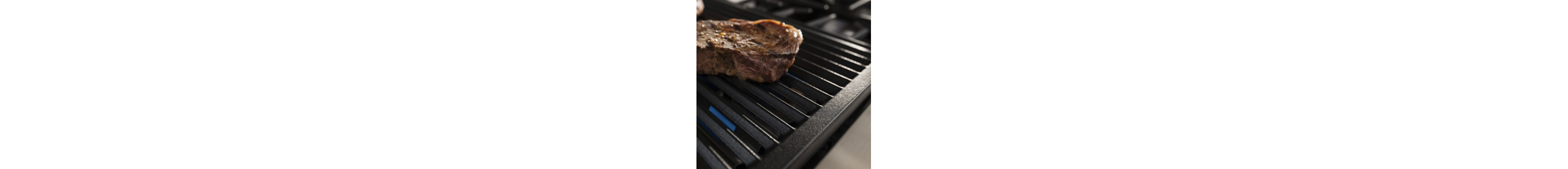 A steak searing on a stove