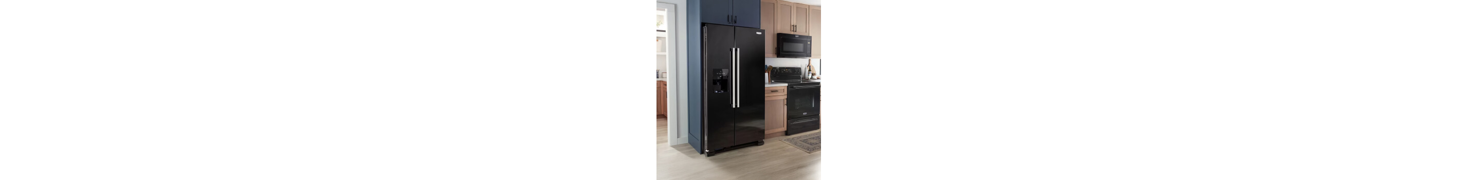 A black refrigerator with a black over-the-range microwave and range