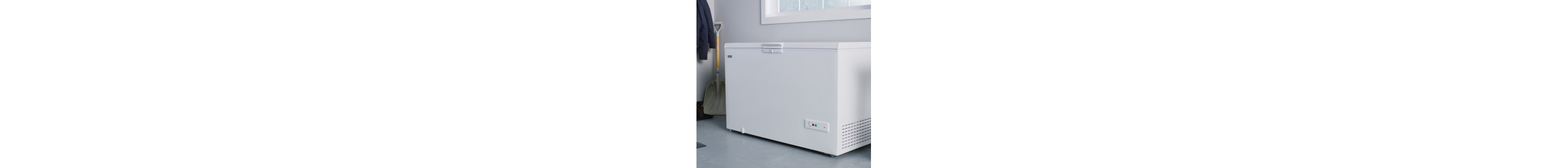 A white chest freezer in a garage
