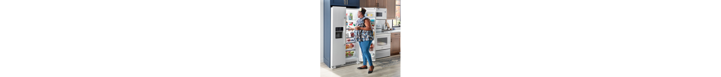 A person looking inside their open refrigerator.