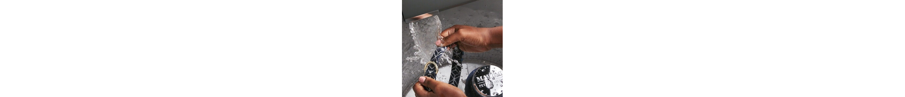 Hands rinsing a collar under water