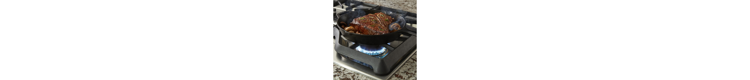 Steak and mushrooms simmering in a cast iron pan