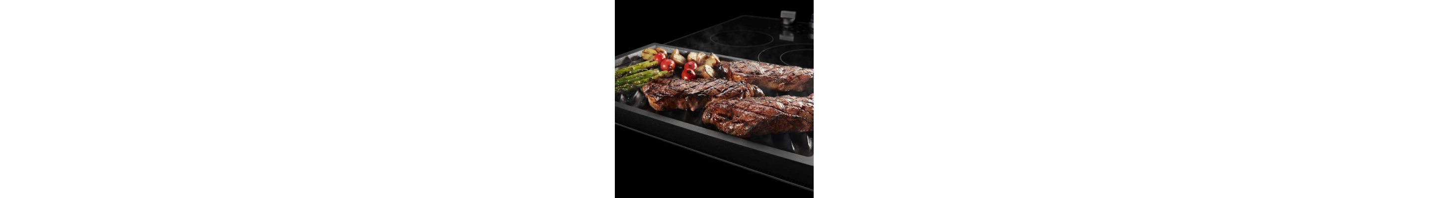 A close-up of food cooking on a Maytag® reversible grill