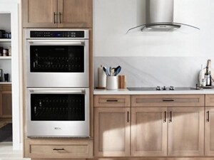A Maytag® electric cooktop, range hood and double wall oven in a modern kitchen