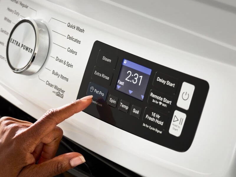 Person selecting settings on a Maytag® front load washer control panel
