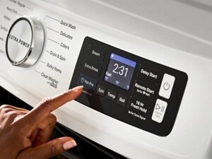 Person selecting settings on a Maytag® front load washer control panel