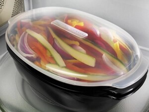 Steamable bowl of cut vegetables inside of a microwave