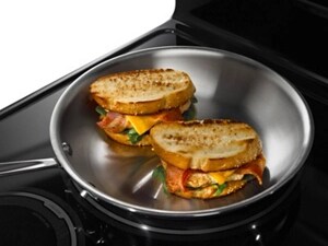 Sandwiches cooking in a stainless steel frying pan
