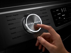 Person selecting the Extra Power Button on a Maytag® washing machine