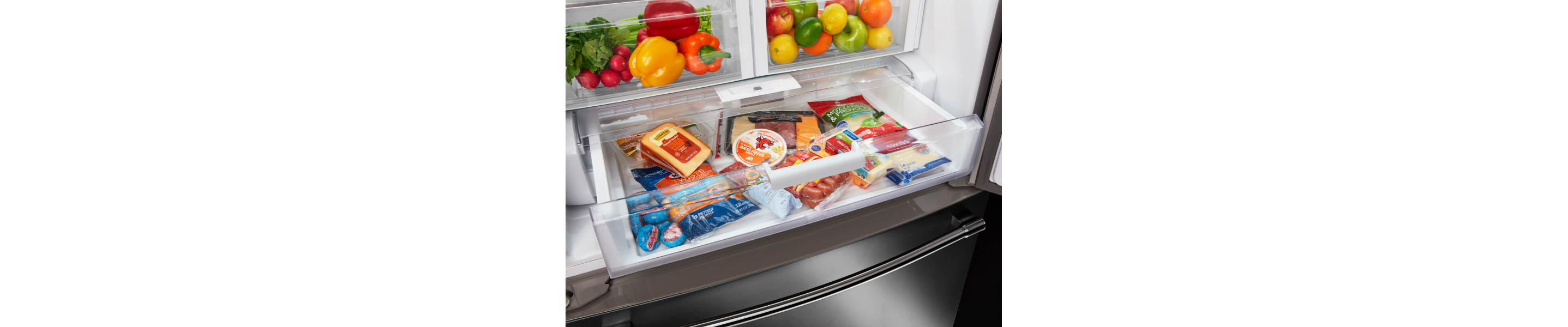 An open drawer inside a refrigerator featuring various deli meats and cheeses