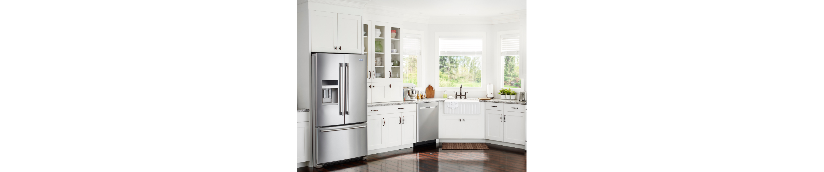 White kitchen with stainless steel French door refrigerator and dishwasher