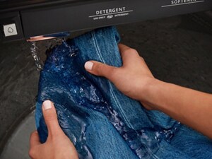 Hands pre-treating denim with built-in water faucet