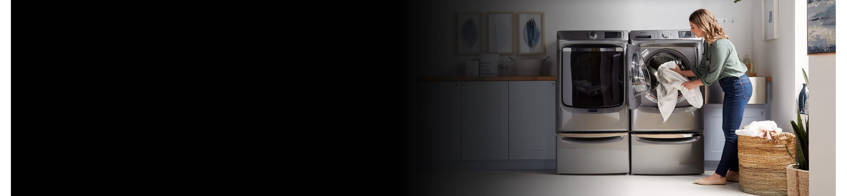 A person taking laundry out of a Maytag® dryer