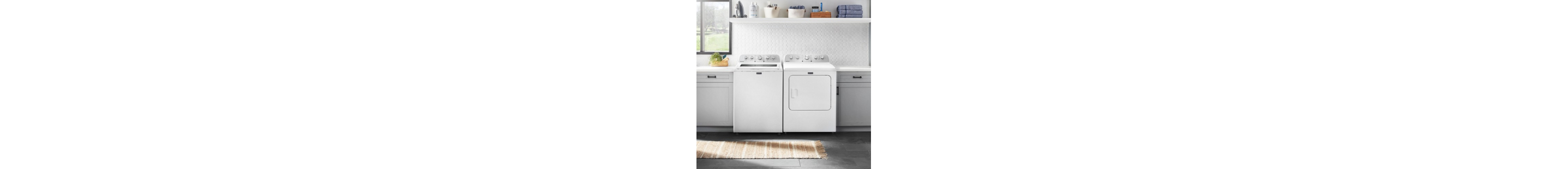 White top load laundry set in a laundry room