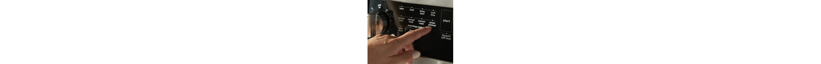 Person selecting a button on a range