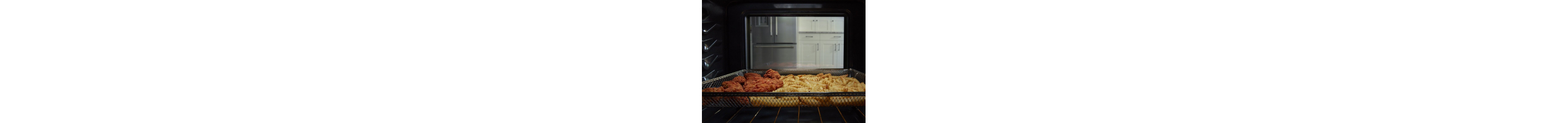 Food cooking in an oven in an air fry basket