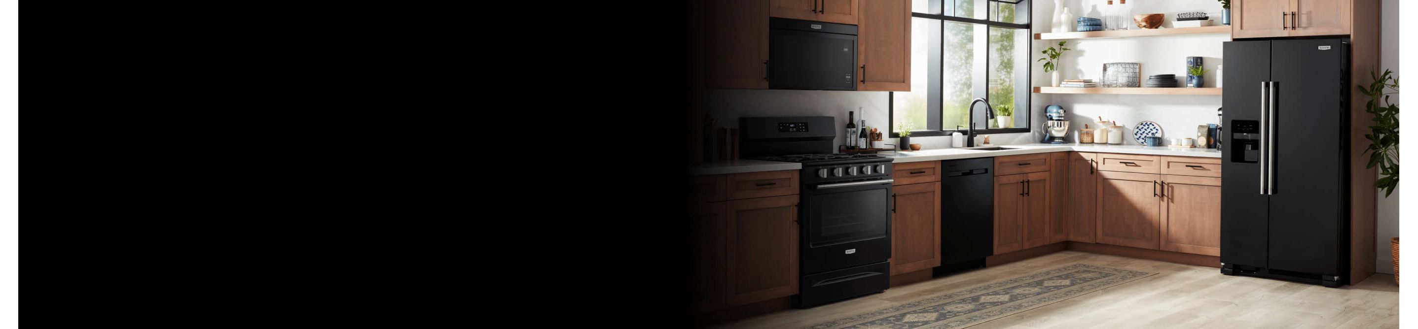 A kitchen with wood cabinets with black fixtures and black appliances