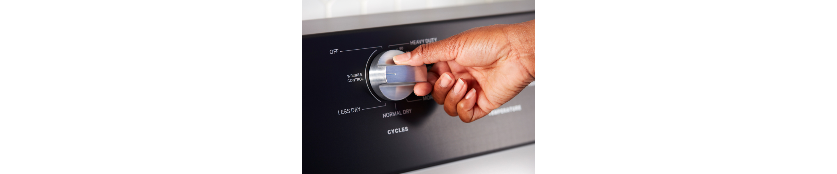Close up of person choosing a setting on Maytag® dryer