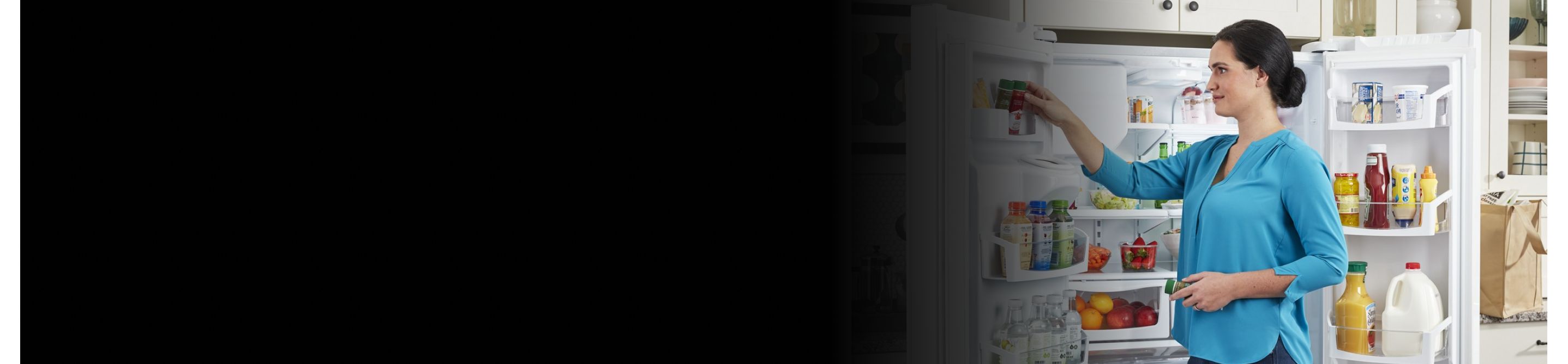Person placing food in side door of refrigerator 