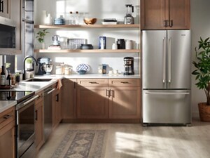 A French door refrigerator in a bright kitchen with warm, brown cabinets