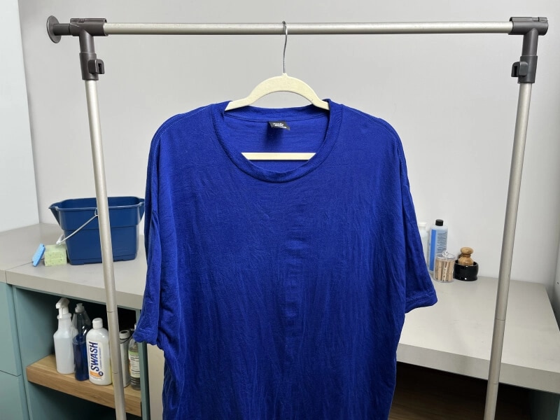 A blue shirt hanging up to dry