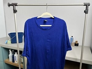 A blue shirt hanging up to dry