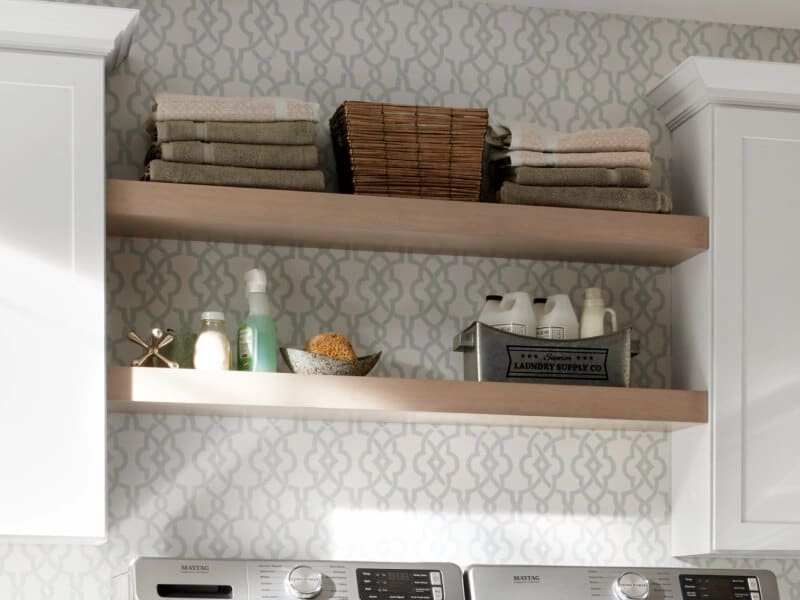 Towels and laundry items on shelves in a laundry room
