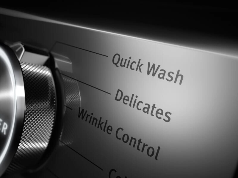A close up of a washer control panel