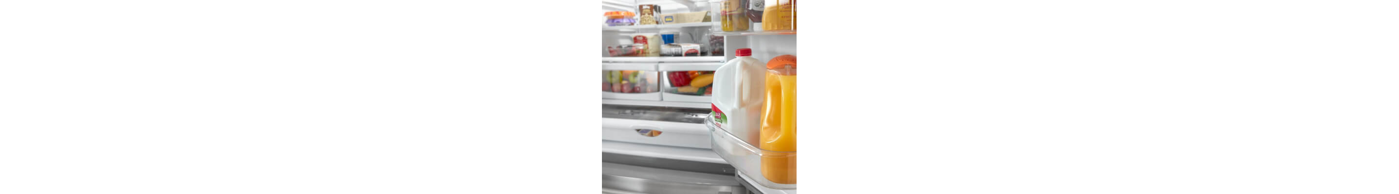 Open refrigerator door with milk and juice in gallon door bins