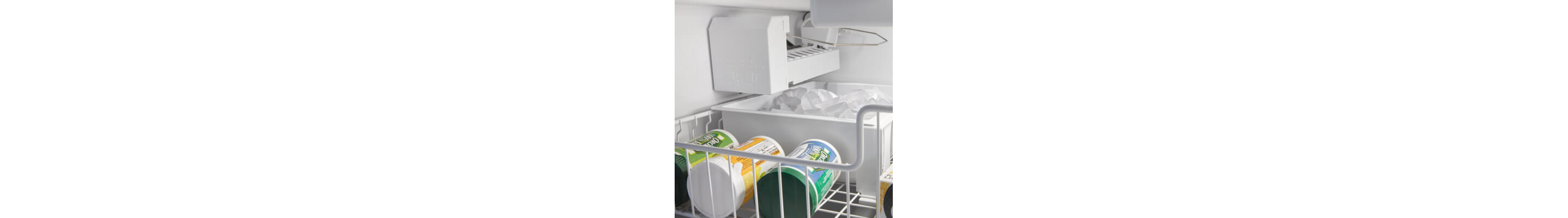 Frozen juice concentrate in front of ice maker in freezer drawer
