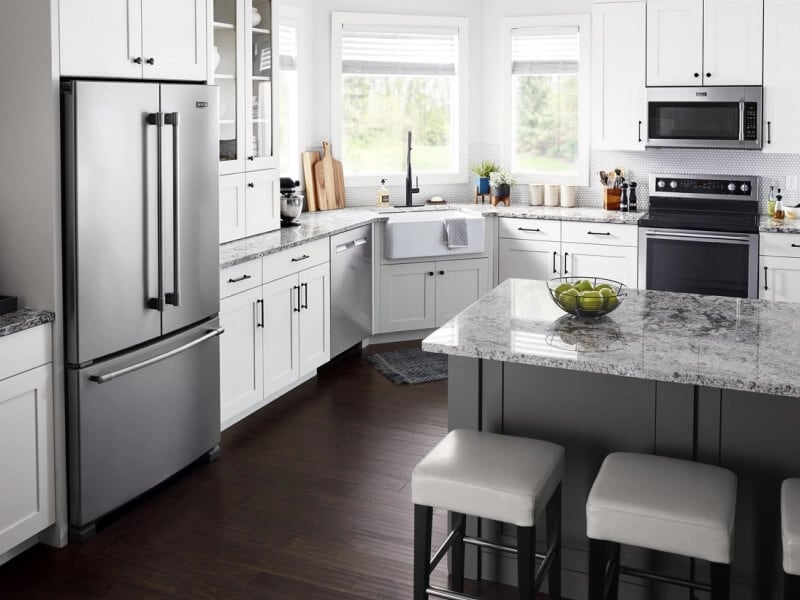 Stainless steel Maytag® French door refrigerator in white cabinetry