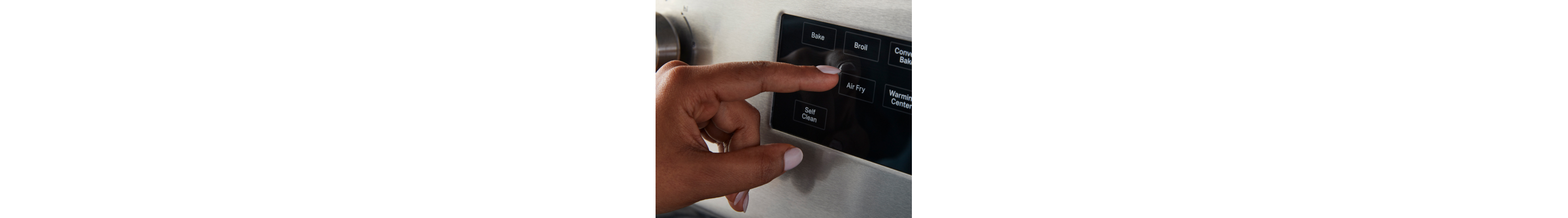 Hand pressing Air Fry button 