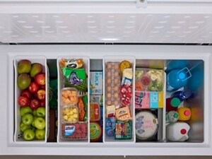 An open chest freezer with food inside