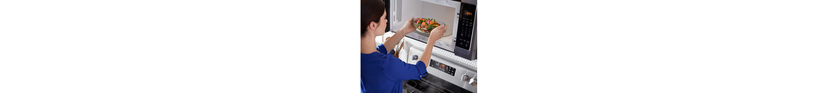 Person putting veggies in the microwave