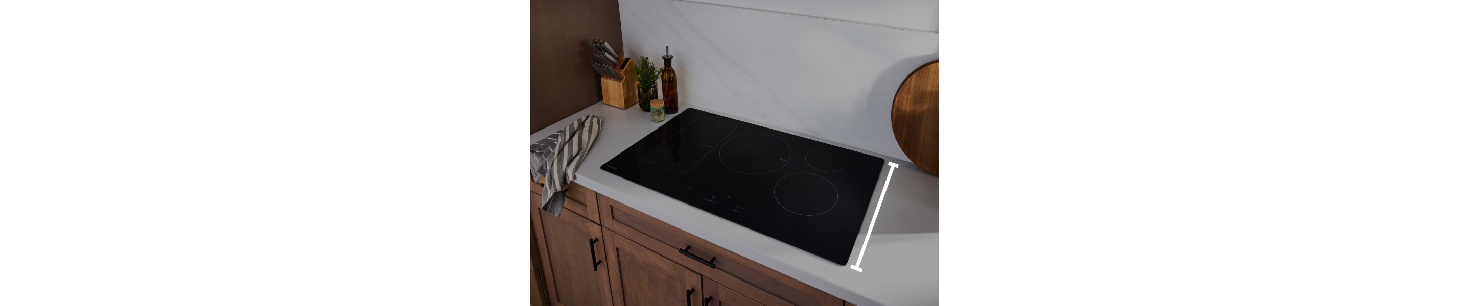 An induction cooktop with a line measuring the depth of the surface