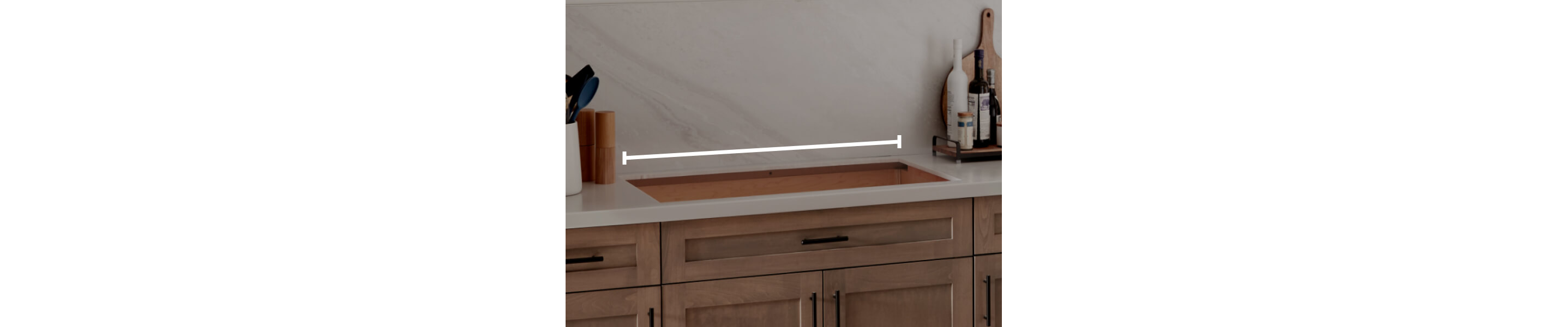 A cooktop cutout within countertops with a line measuring the width of the cutout