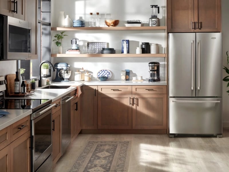 Maytag® French door refrigerator in modern kitchen with brown cabinetry