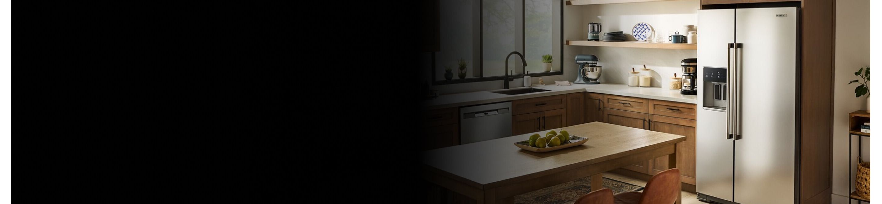 Kitchen with stainless steel Maytag® side-by-side refrigerator with an external ice and water dispenser
