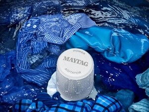 A close-up of clothes during a wash cycle in a Maytag® washer