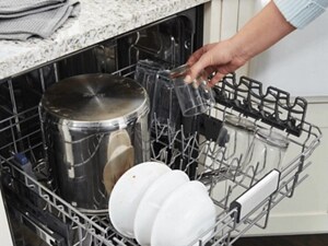  Person putting glasses on top rack of dishwasher