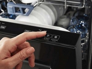 Person selecting dishwasher cycle on a top control dishwasher panel