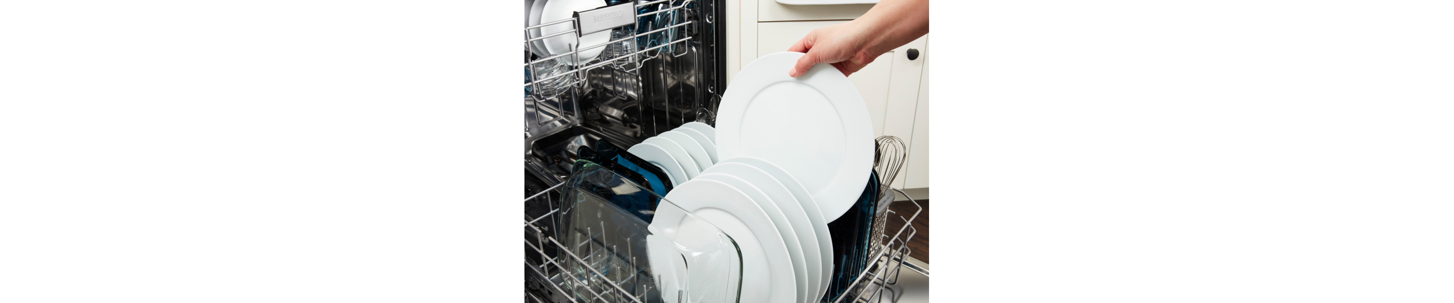 Person removing clean plate from a dishwasher.