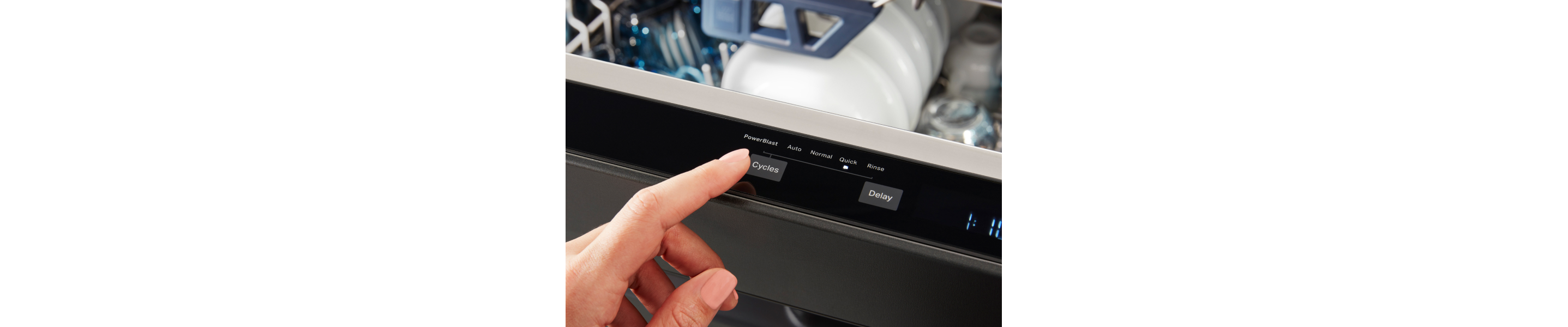 Person selecting a cycle on a dishwasher.