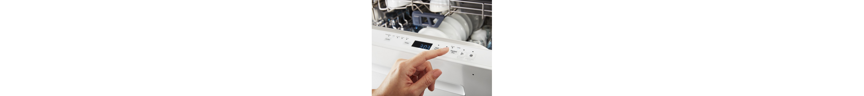 Person selecting dishwasher cycle on control panel